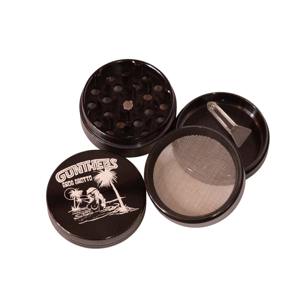 Black grinder with mesh screen and other components on a white background