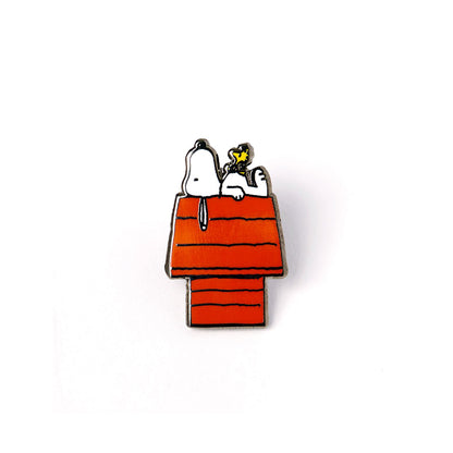 Pin with Snoopy and Woodstock on a doghouse against a white background