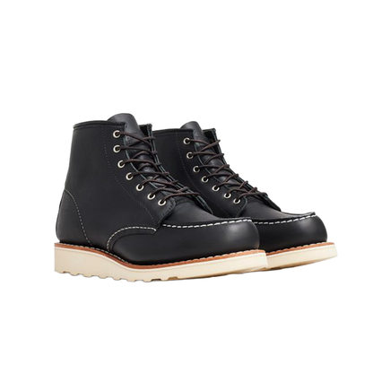 Black leather boots with white soles on a white background