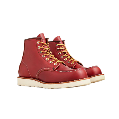 Red leather boots with yellow laces on a white background