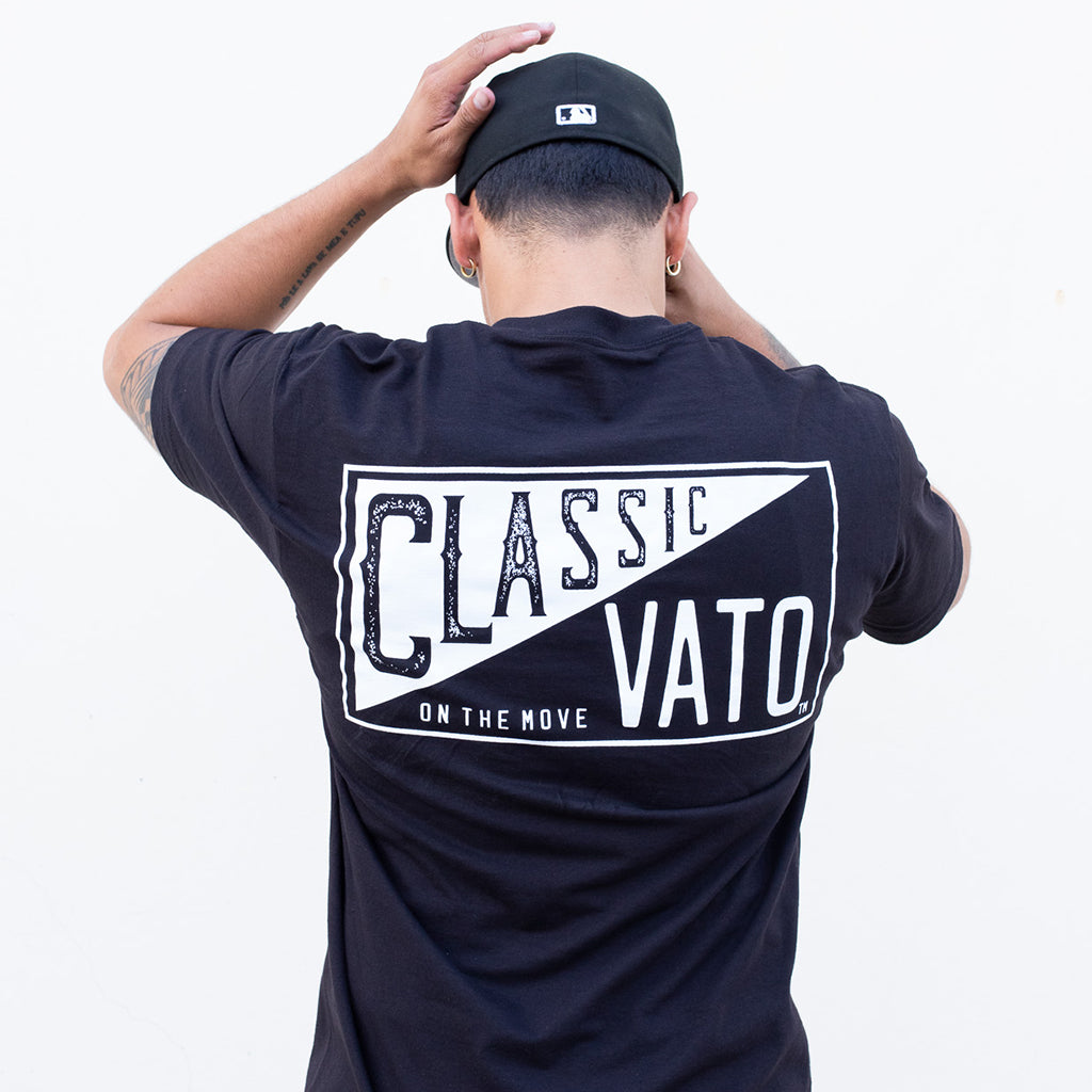 Person wearing a navy blue t-shirt with 'Classic Vato' text on the back, against a white background