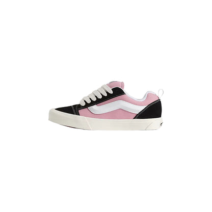Pink and black sneaker with white sole on a light gray background