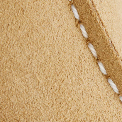Close-up of beige fabric with a white thread running through it