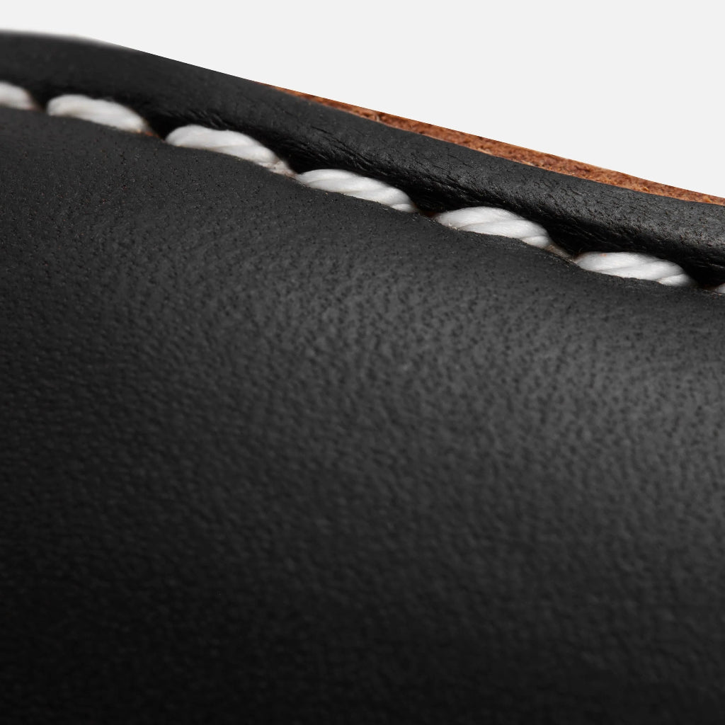 Close-up of black leather with white stitching detail