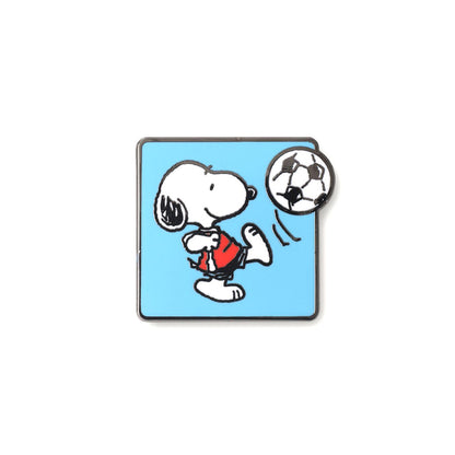 Snoopy playing soccer pin on a blue background