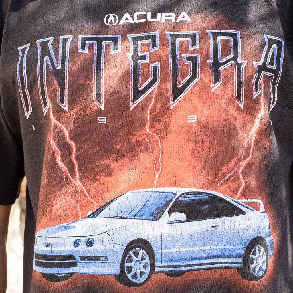 T-shirt with Acura Integra graphic design featuring a car and lightning effects.