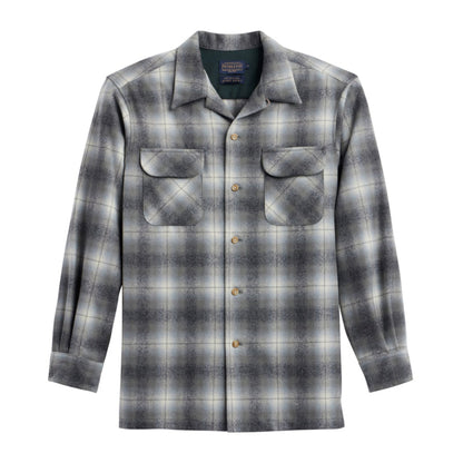 A long-sleeved, button-up checkered shirt in shades of grey and green, with two bias-cut pockets.