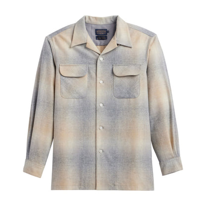 A long sleeve button-up shirt with a ombre color design transitioning from grey to tan, featuring two bias-cut pockets.